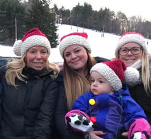 Load image into Gallery viewer, Family posing outside in the snow in their Santa hats