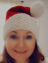 Load image into Gallery viewer, Smiling woman wearing Santa hat