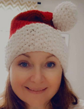 Load image into Gallery viewer, Smiling woman wearing Santa hat
